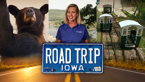 A stuffed black bear, Brooke Kohlsdorf (host), the Fenelon Place Elevator Company trolly cars on a hillside and Road Trip Iowa logo above a sunlit two lane highway.