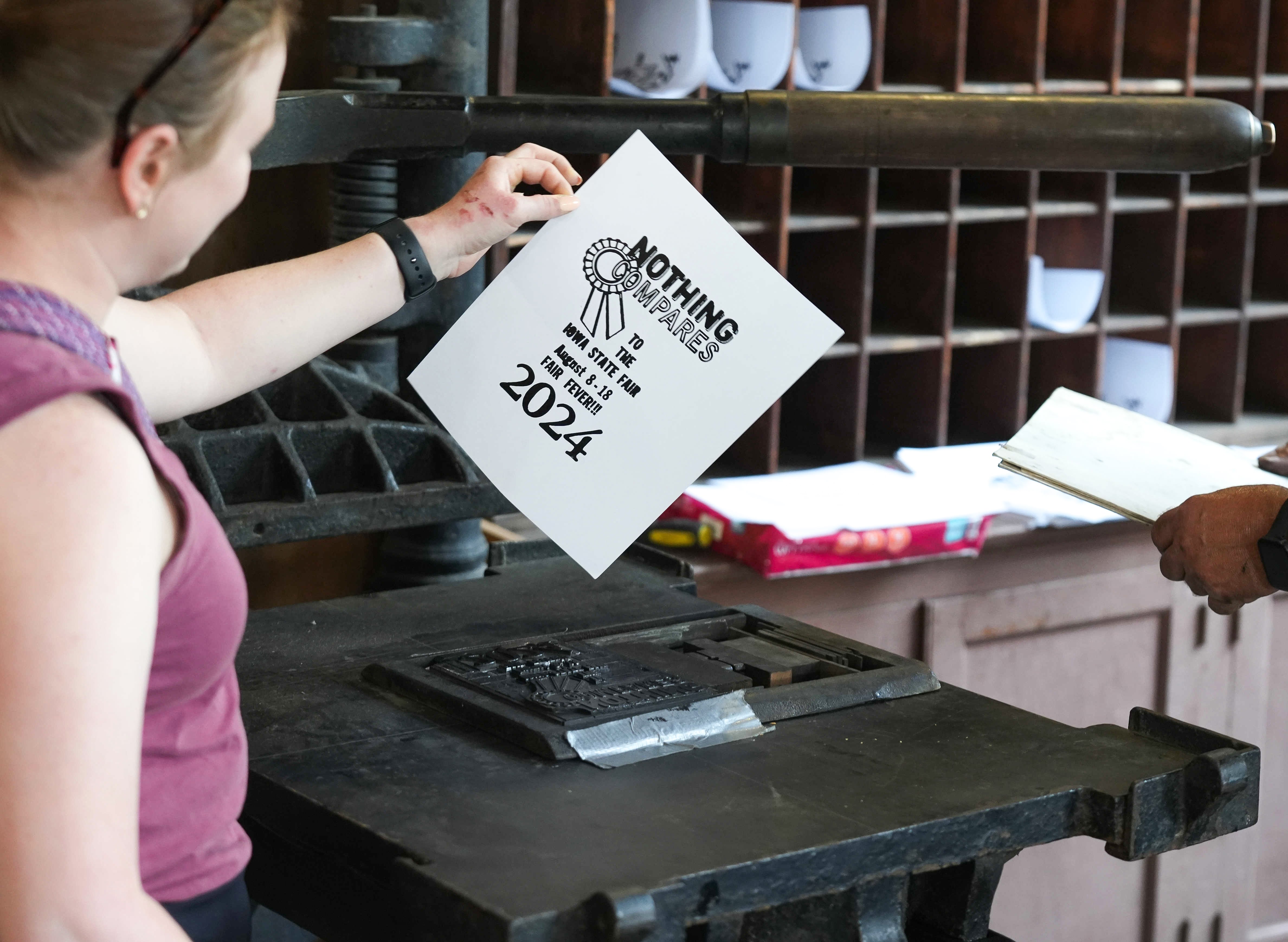 Printing press paper that reads "Nothing compares to the Iowa State Fair August 8-18 Fair Fever! 2024"