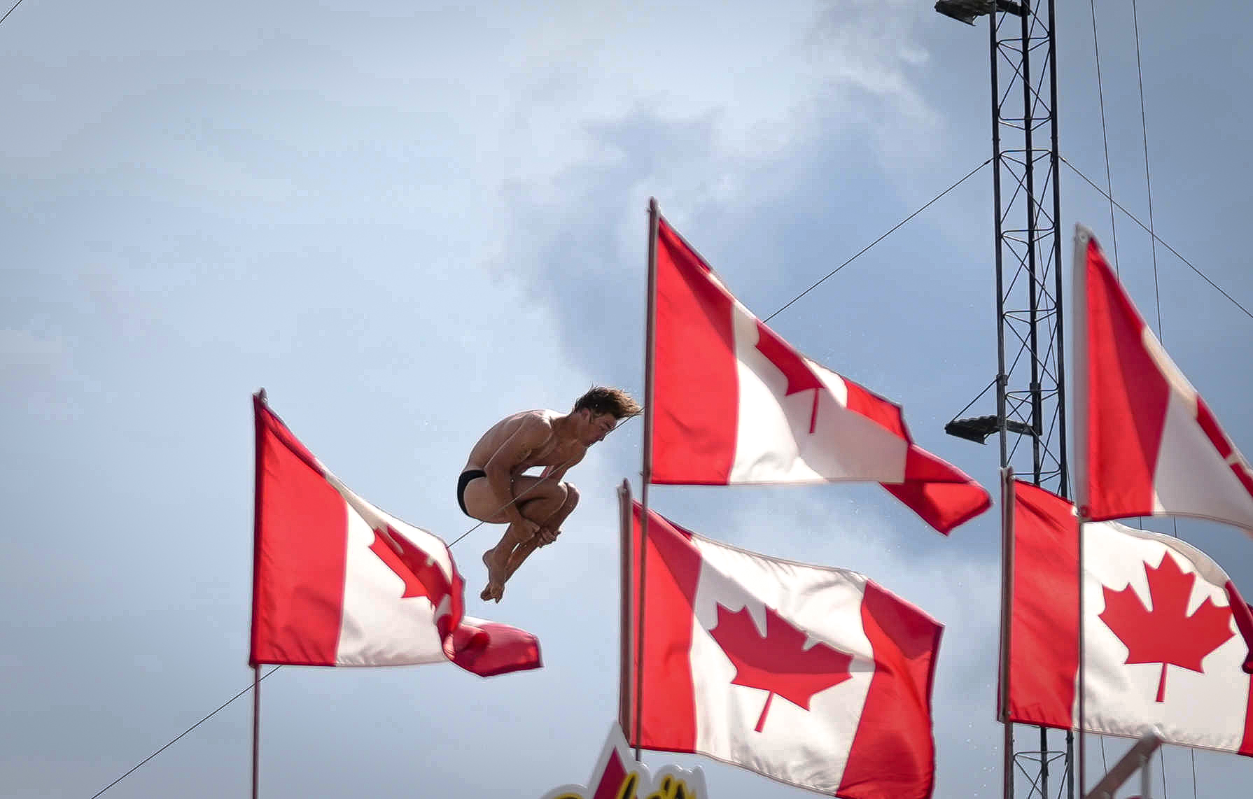 A member of the Flying Fools Dive Show falls from the platform into a pool of water 