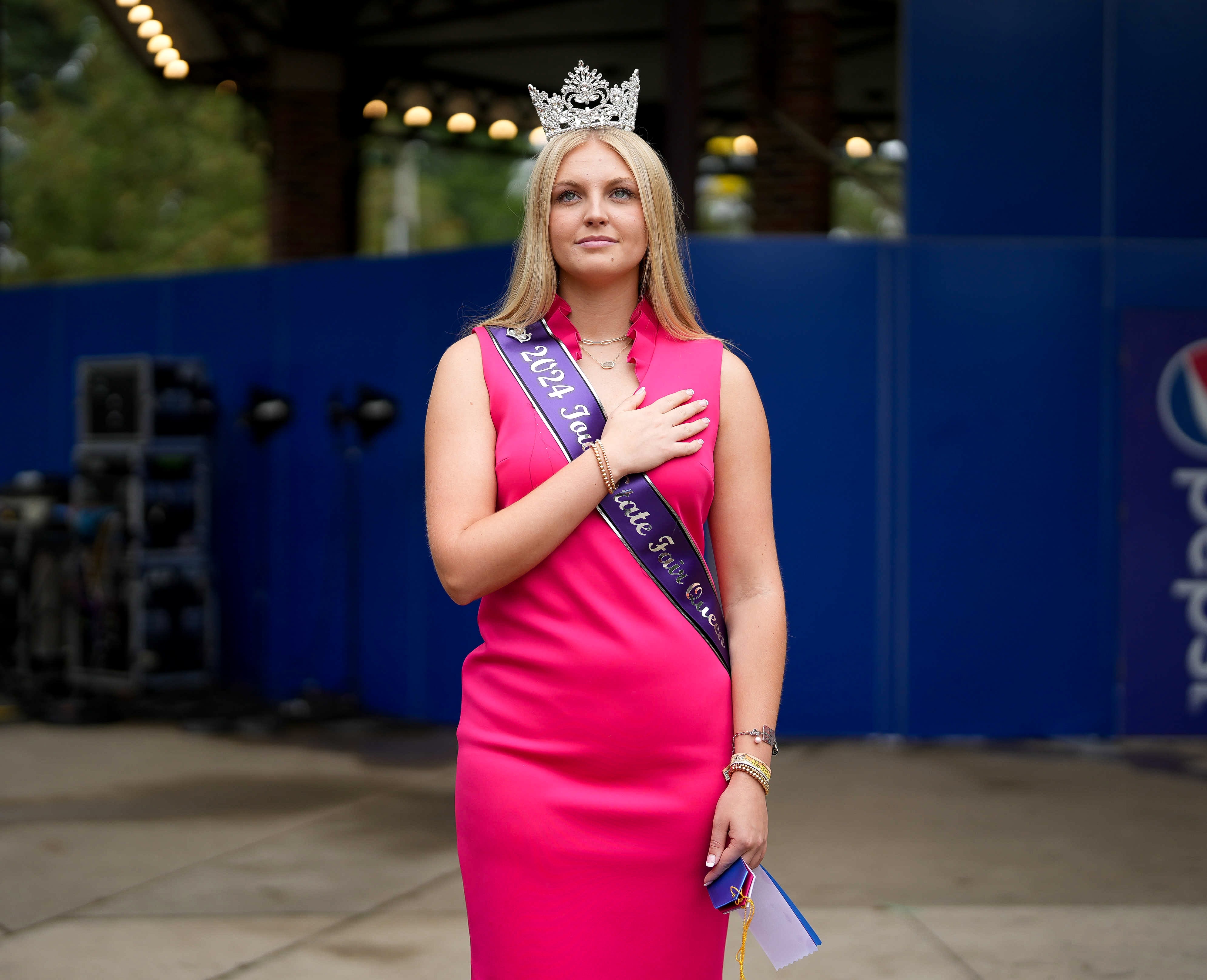 Iowa State Fair Queen Elli Clarke stands for the daily National Anthem. 