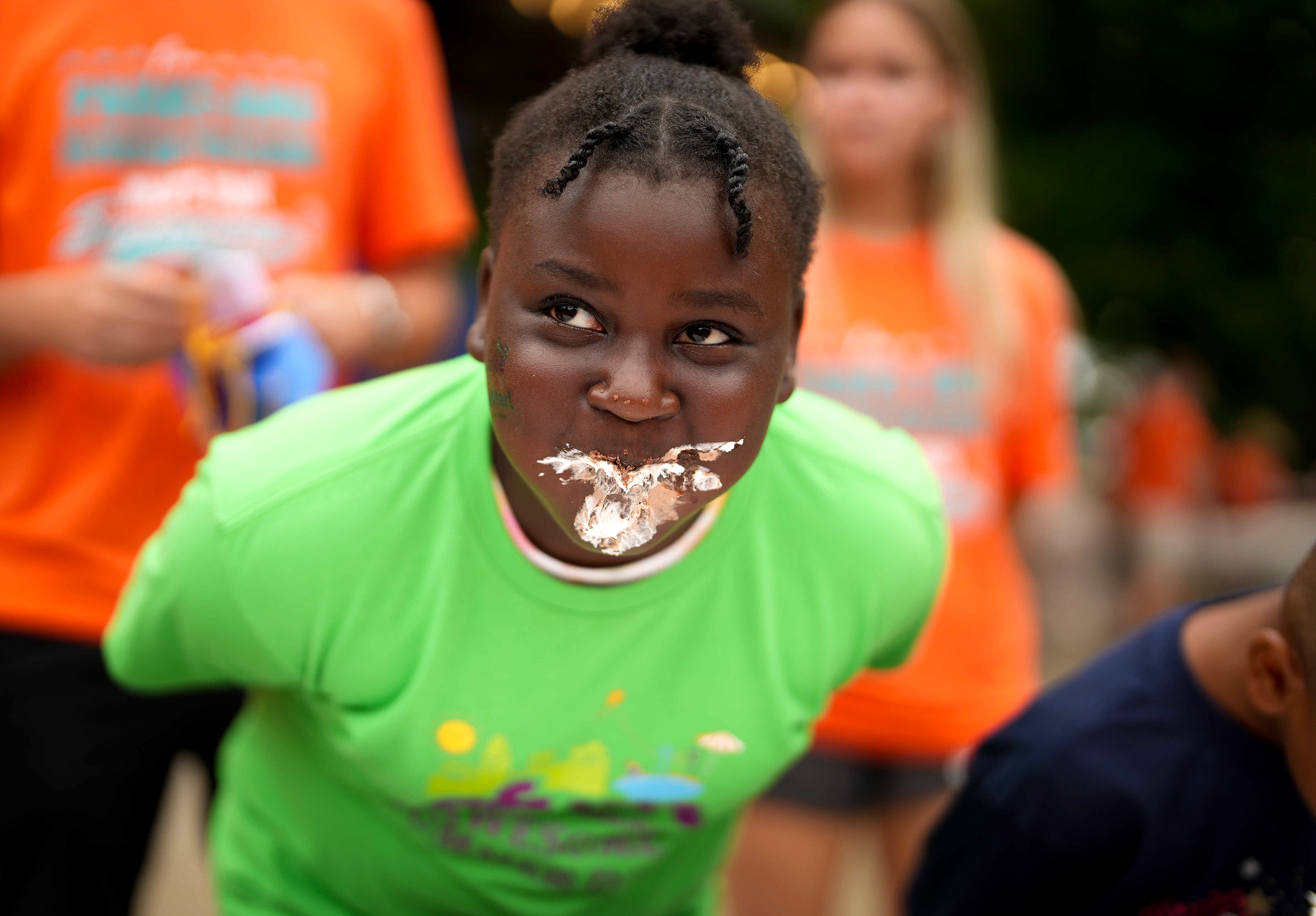 A messy but fun pie eating contest for kids on Parks and Recreation Day.