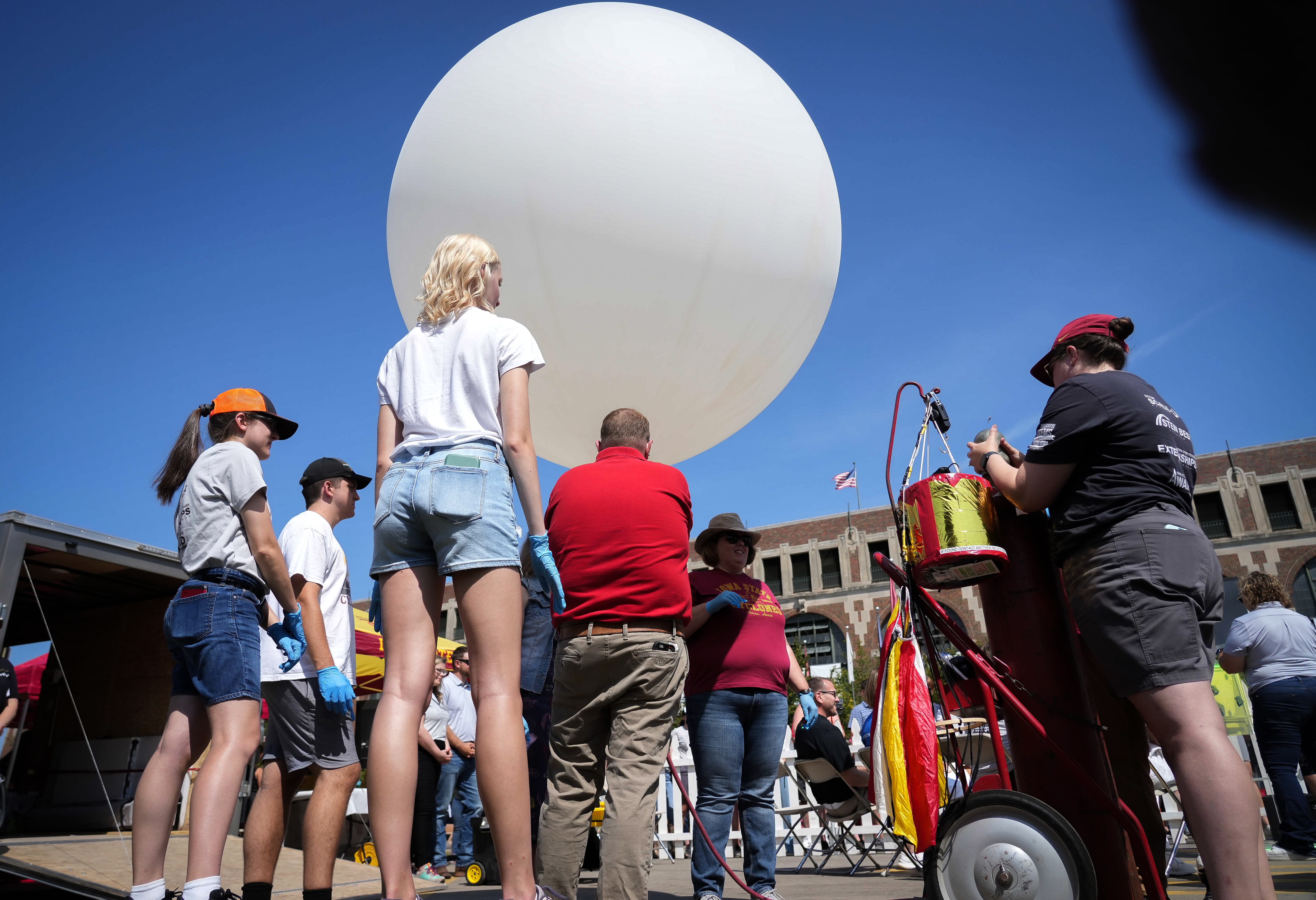 Fairgoers gathered around the Grand Concourse to see a high-altitude weather balloon launch, part of Sunday’s STEM theme.