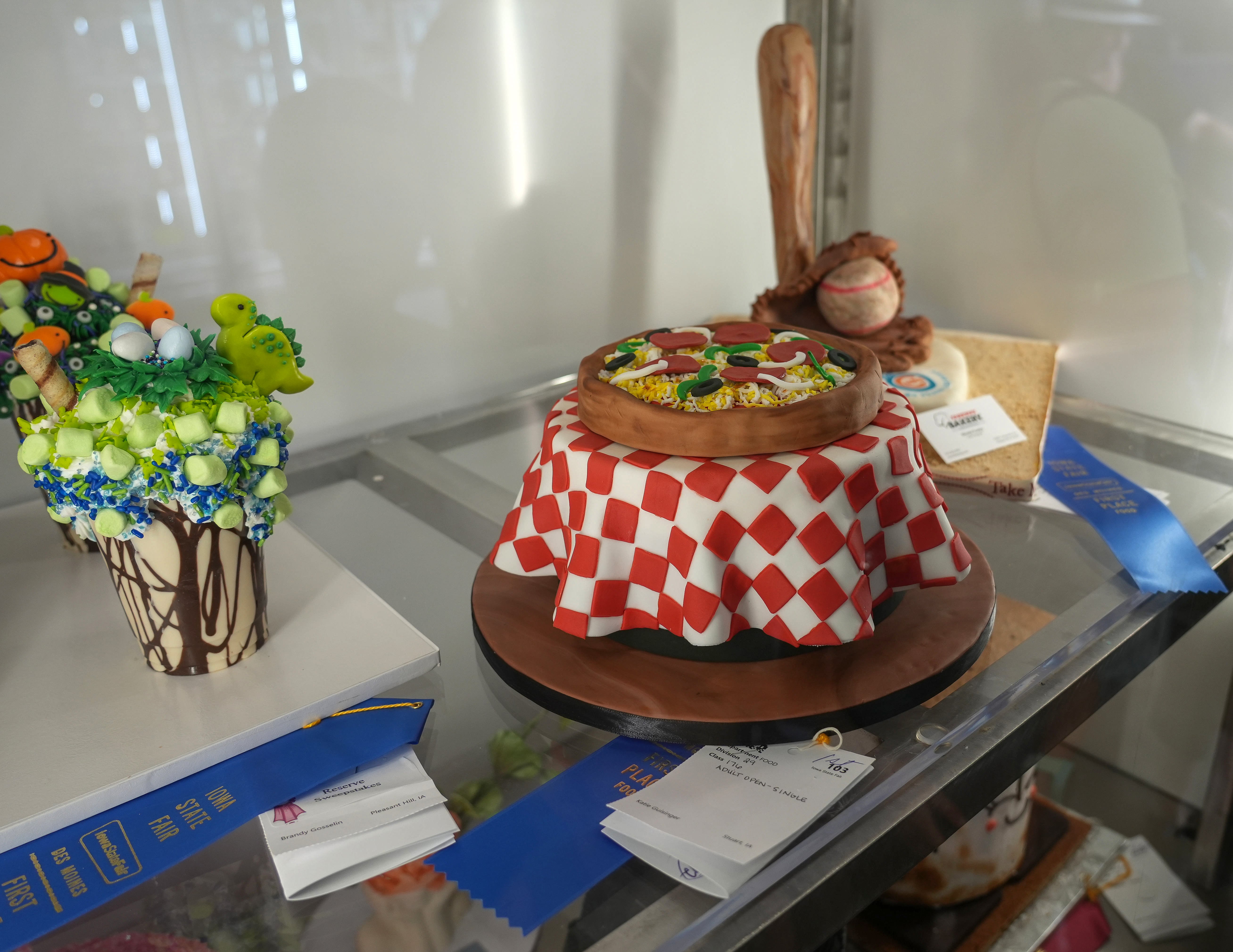 Mini dessert made to look like a table with a checkered tablecloth and a pizza on top.