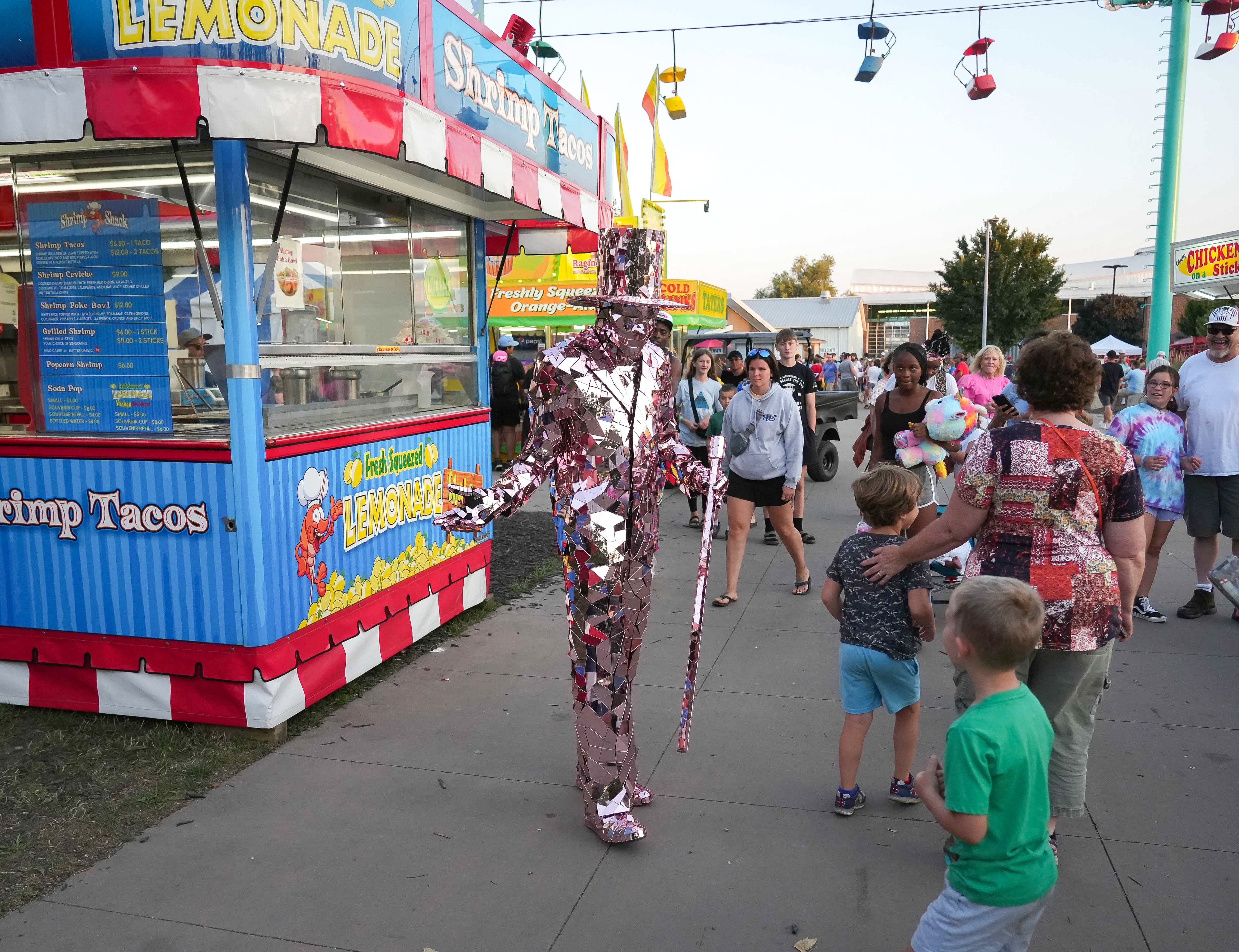 Man in a mirrored costume strolling the fairgrounds