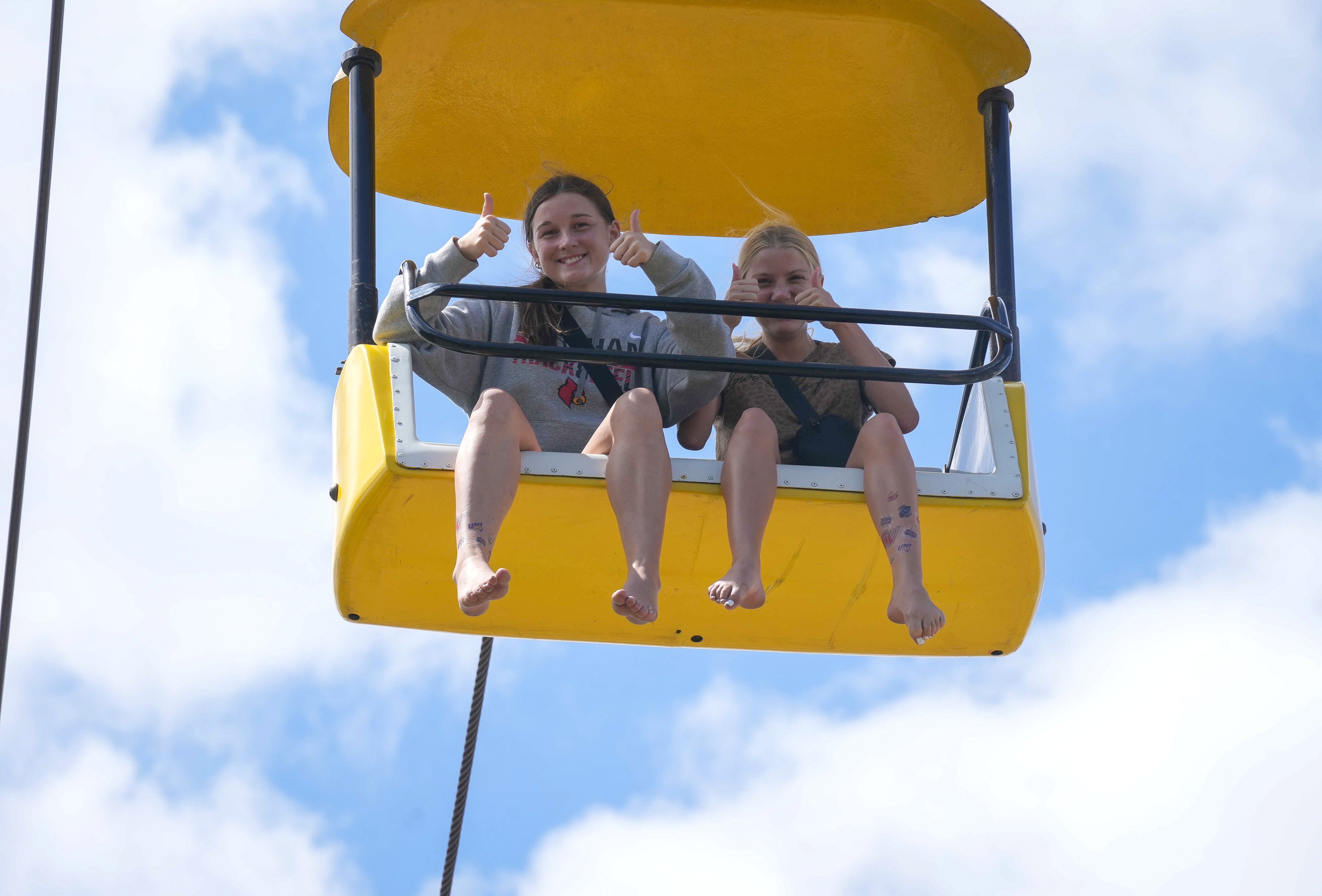 Two fairgoers enjoying a ride on the SkyGlider