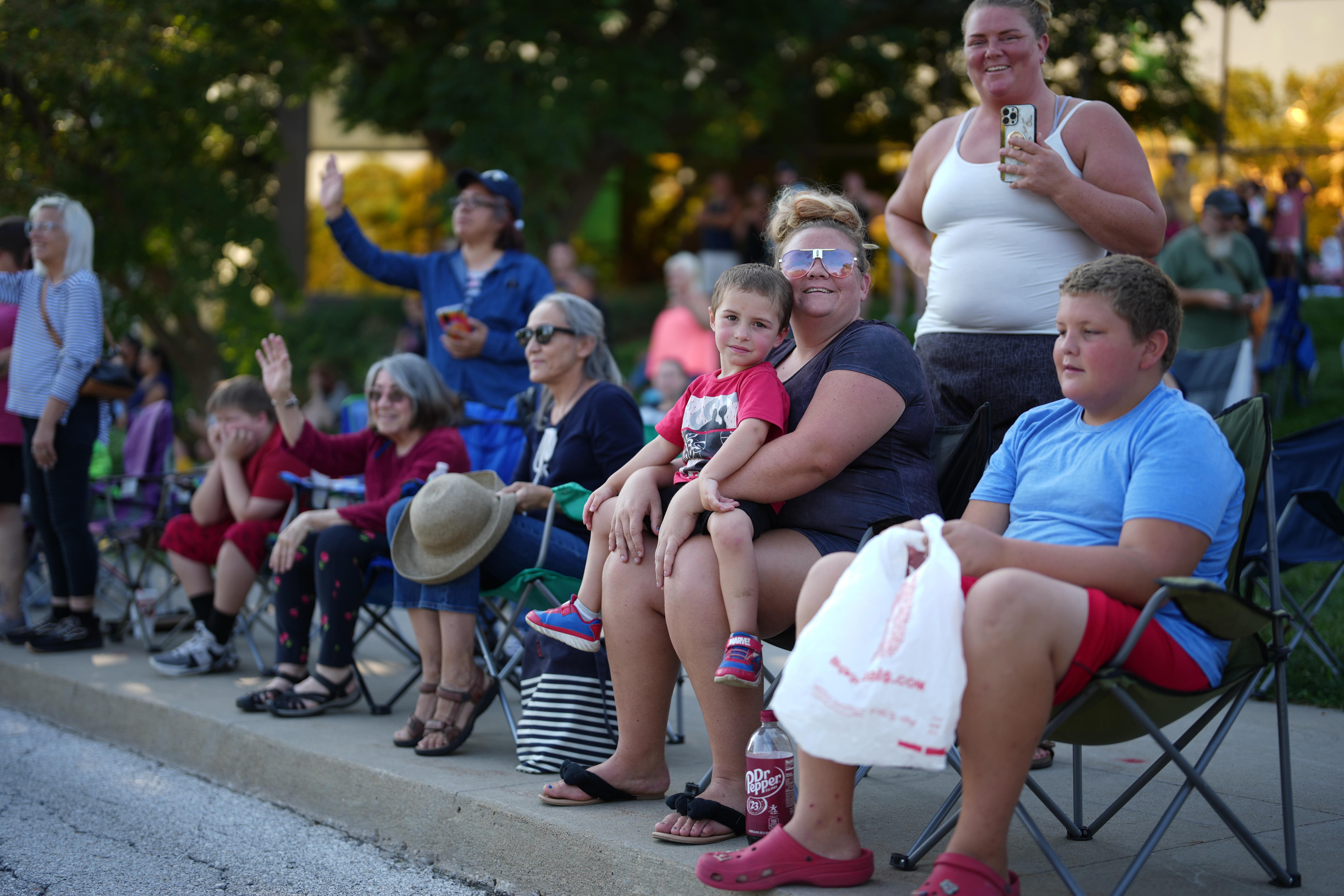 Parade observers line the streets watching the floats go by. 