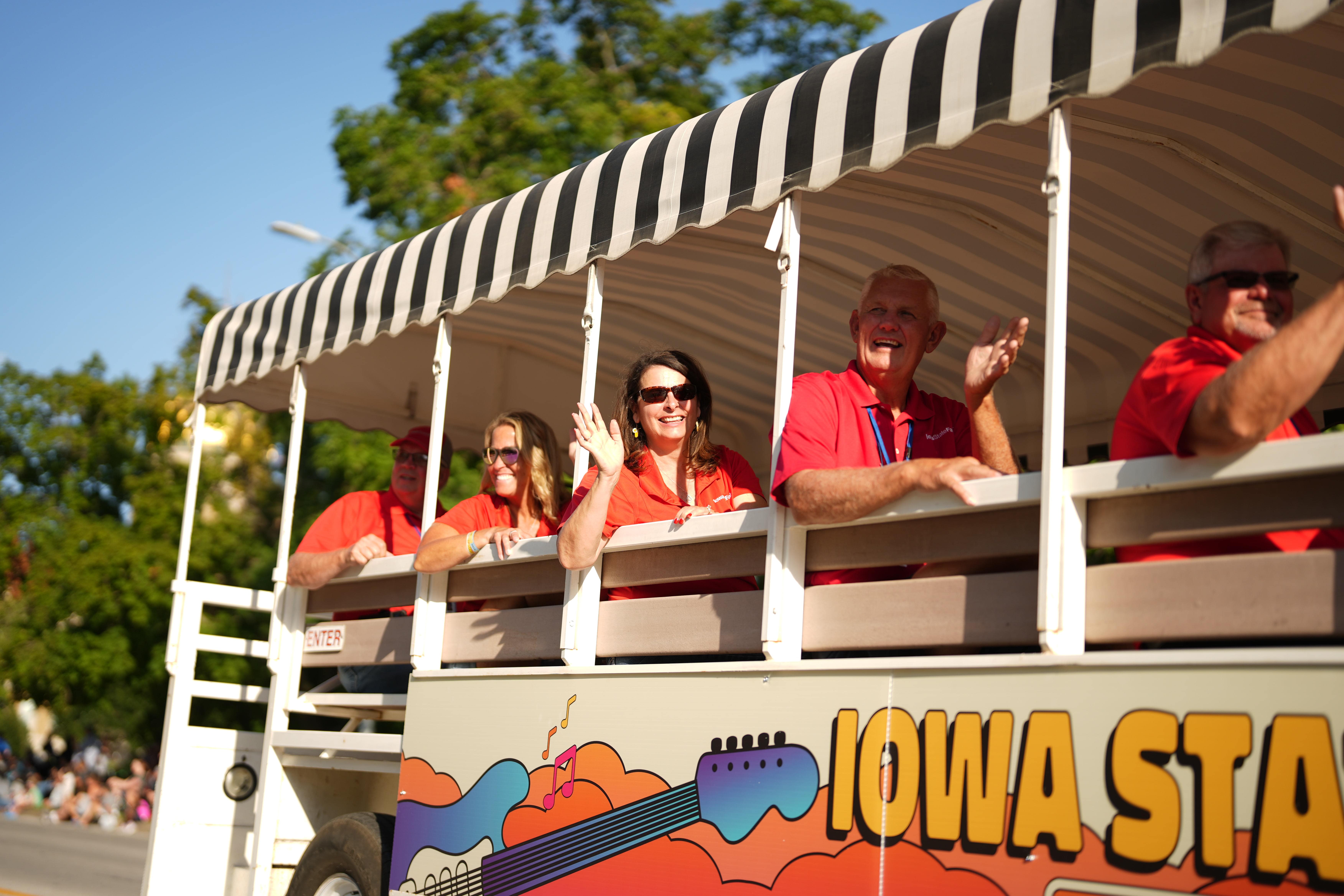 Members of the Iowa State Fair Board wave from their float.