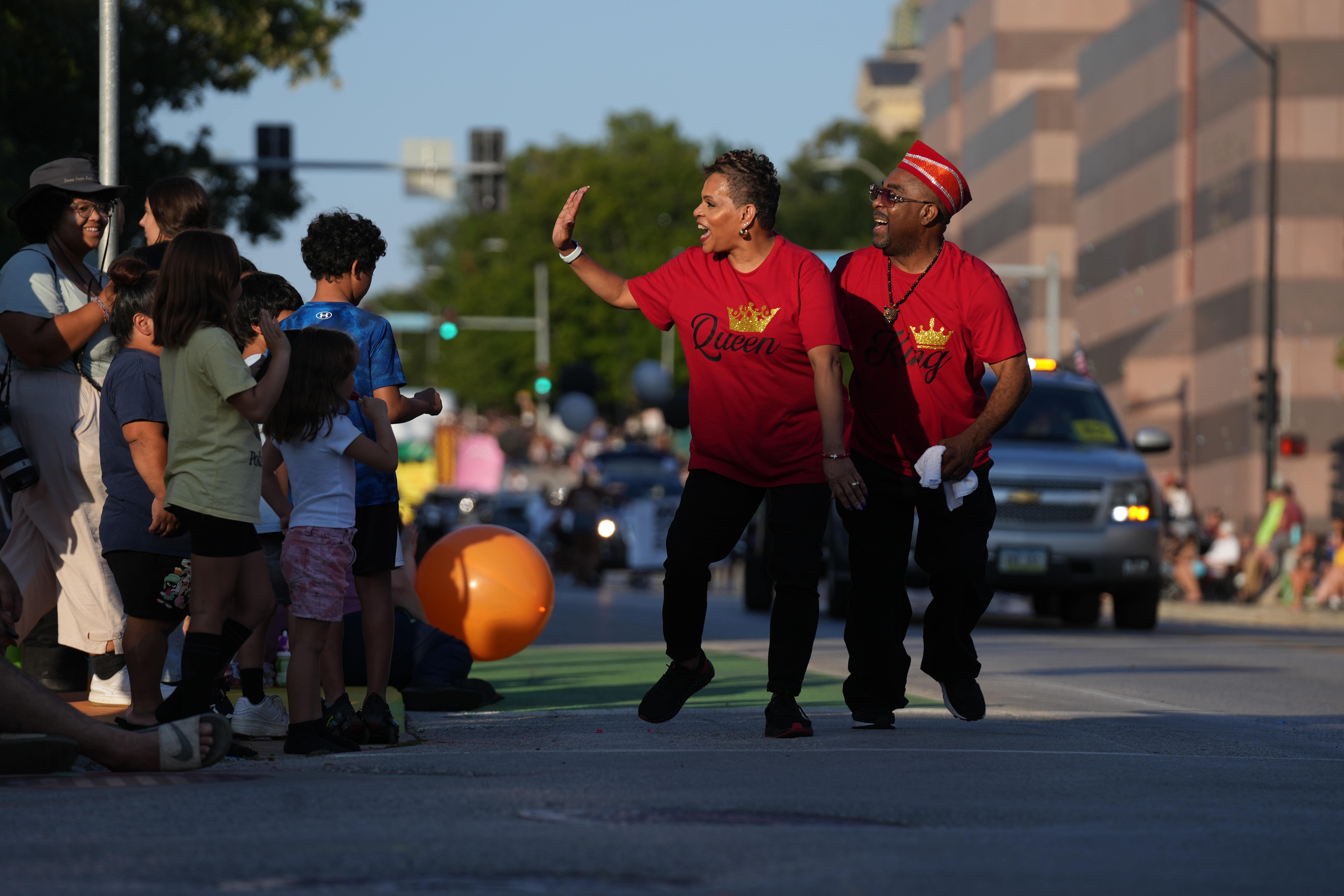 Members of the Iowa Juneteenth Association interacting with the crowd.