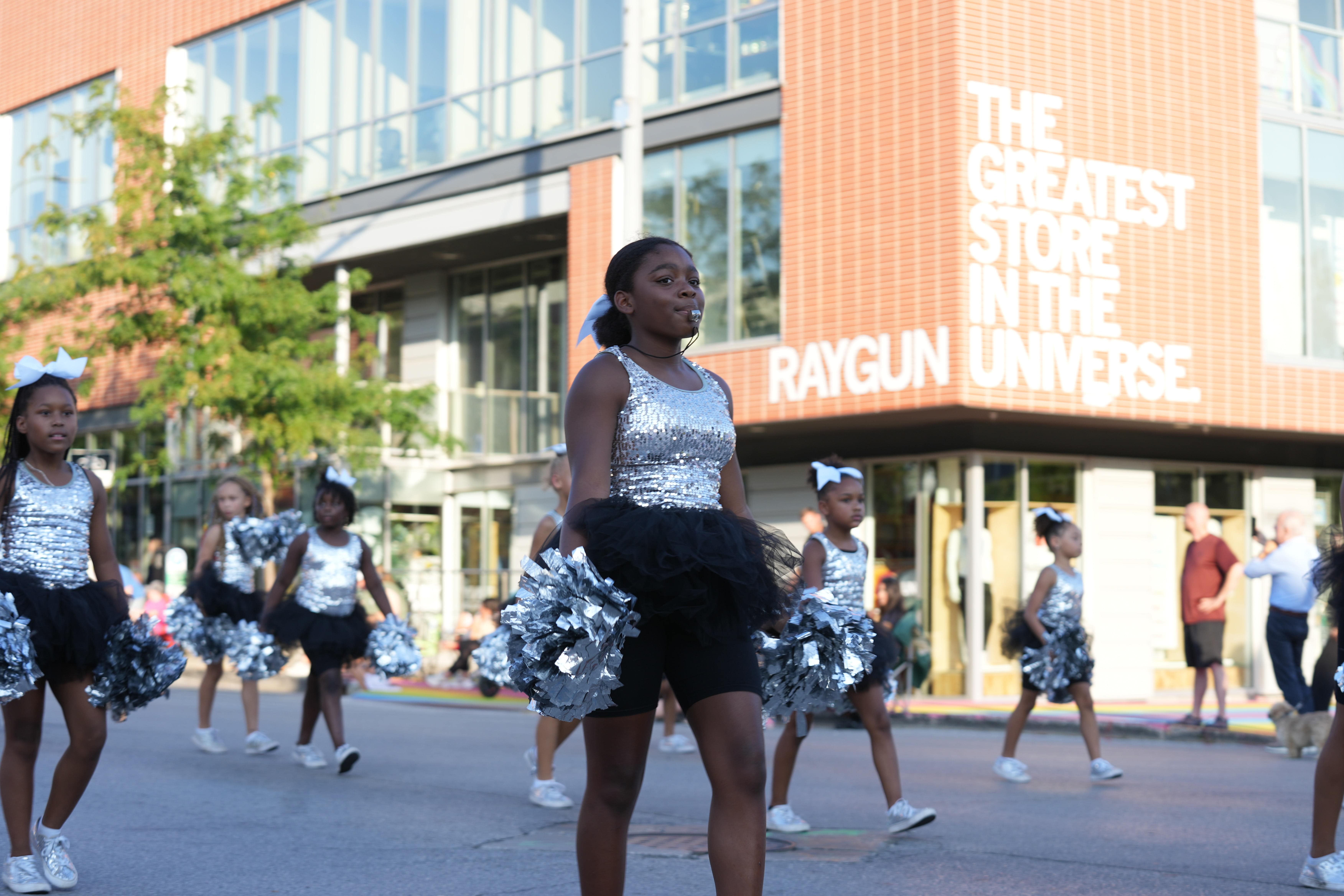 Silver-clad dancing crew marching in the Fair parade. 