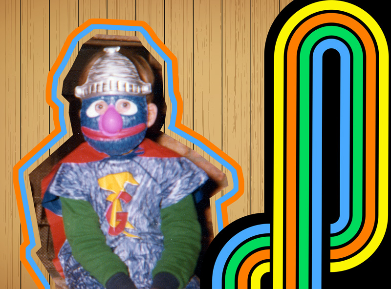 A child dressed in a grover costume with a plastic mask.