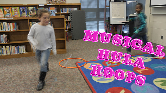 A child playing musical hula hoops