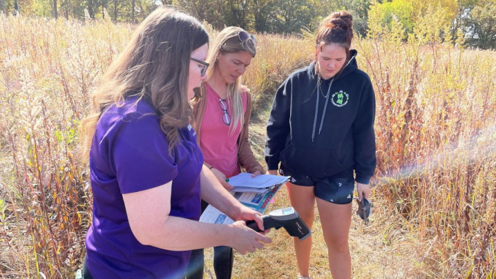 Three teachers standing outdoors looking at nature