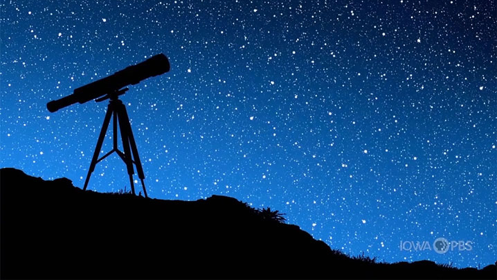 A telescope standing on a hill under a starry sky.