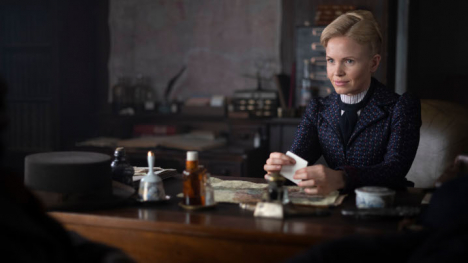 Eliza Scarlet sitting at a desk