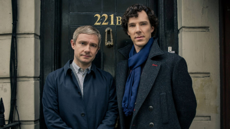 Sherlock Holmes and Dr. Watson standing in front of a door