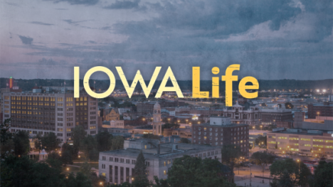 An airial view of the Des Moines skyline with text Iowa Life over the image