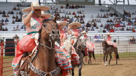 Woman atop a horse and in traditional clothing for the Charros performance