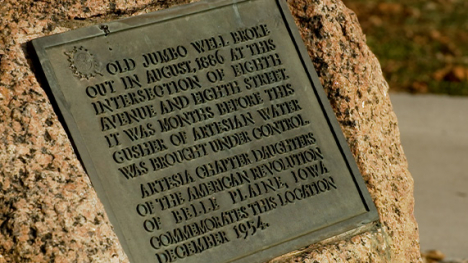 A metal plaque attached to a rock