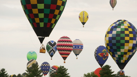 colorfull hotair balloons lifting off into the sky