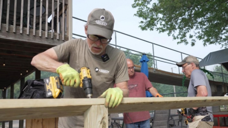 A man building something out of wood using power tools