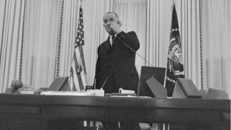 President Lyndon B. Johnson standing in the Oval Office on a phone call days after becoming president in 1963.