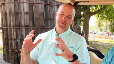 Mike Naig on a golf cart